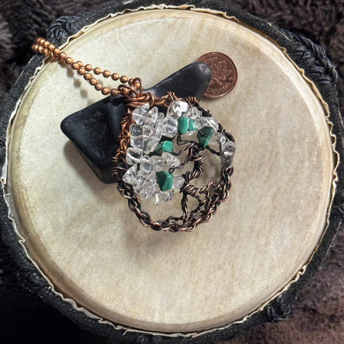 Malachite and icy clear quartz Tree of Life necklace styled over black shungite with a 28-inch copper ball chain and penny for scale.