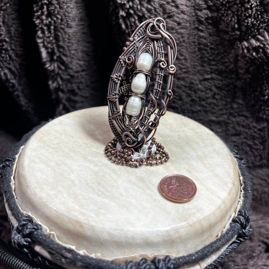 Decorative necklace with pearls on a white stone surface