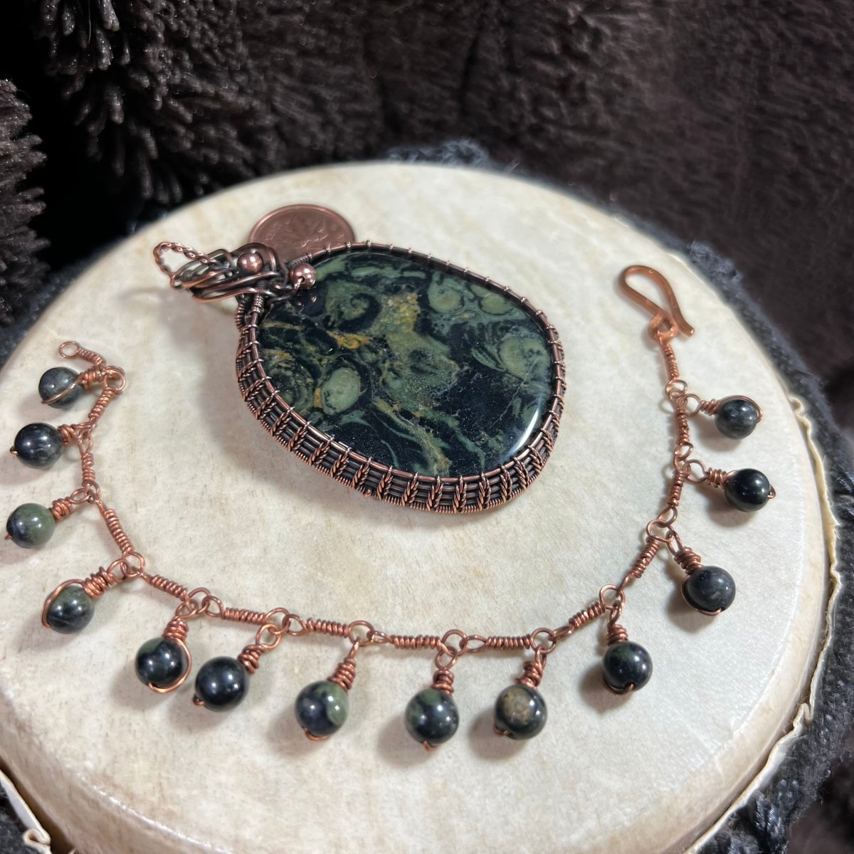 Kambaba Jasper bracelet with matching pendant showing deep green fossil-patterned stone and copper wire wrap.