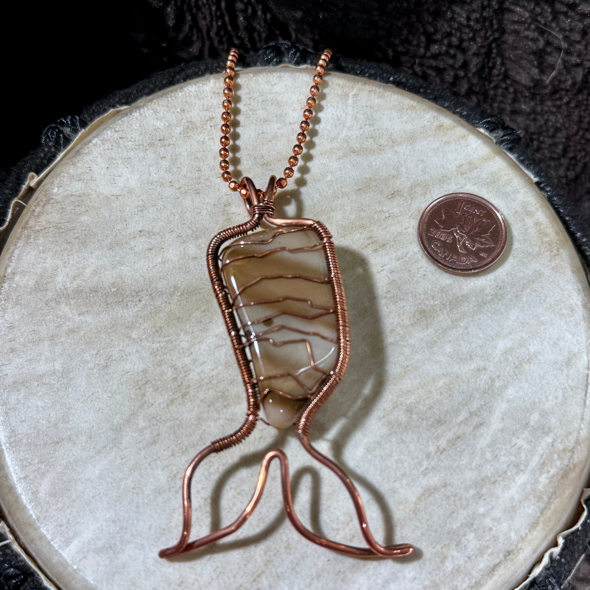 Rear view of a handcrafted Bay of Fundy Jasper Mermaid Tail pendant wrapped in reclaimed copper, highlighting the secure artisan wirework and one-of-a-kind natural stone.