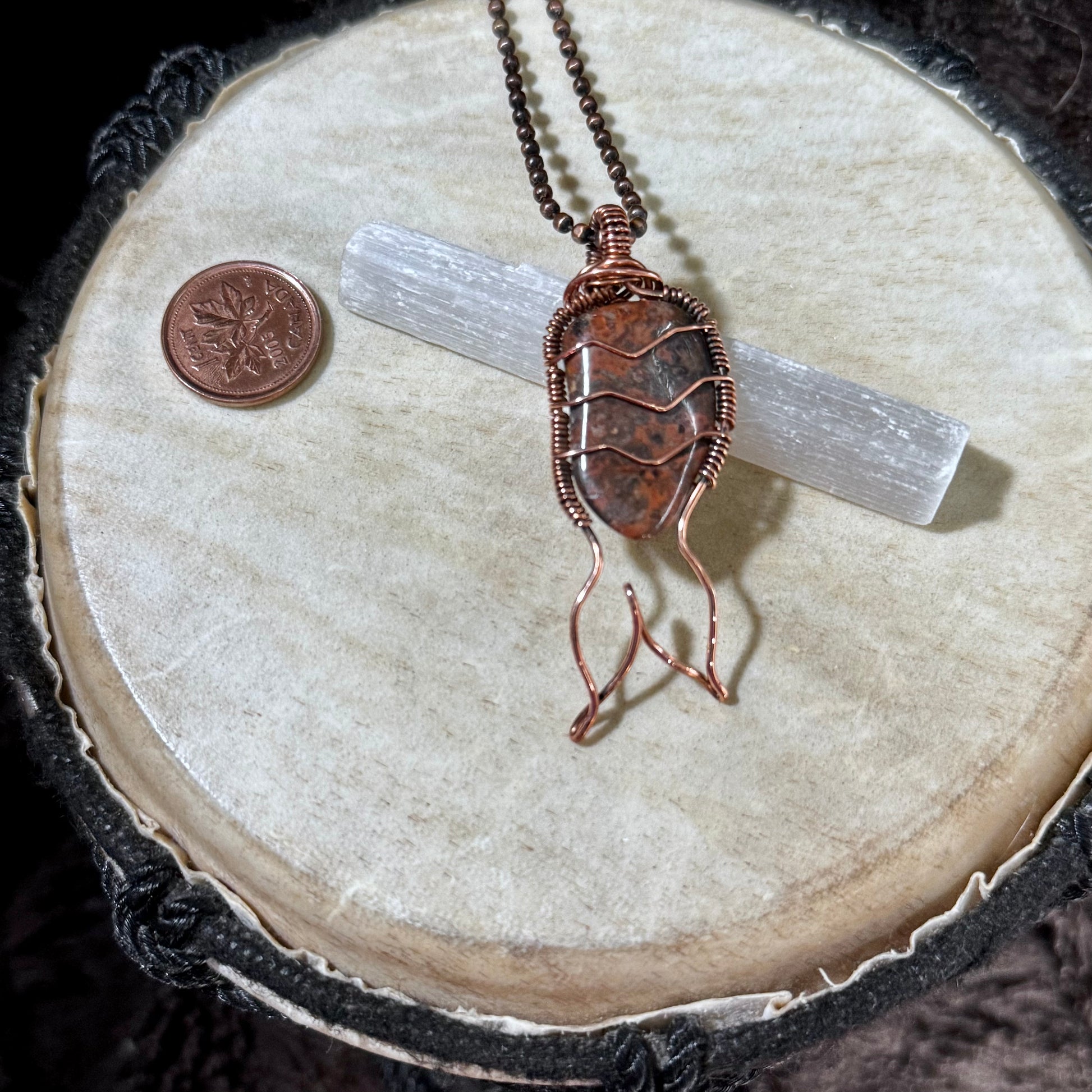 Handmade Leopard Skin Jasper Mermaid Tail Necklace wrapped in reclaimed copper, featuring a natural spotted jasper gemstone with warm brown and charcoal tones and an elegant flowing mermaid tail.