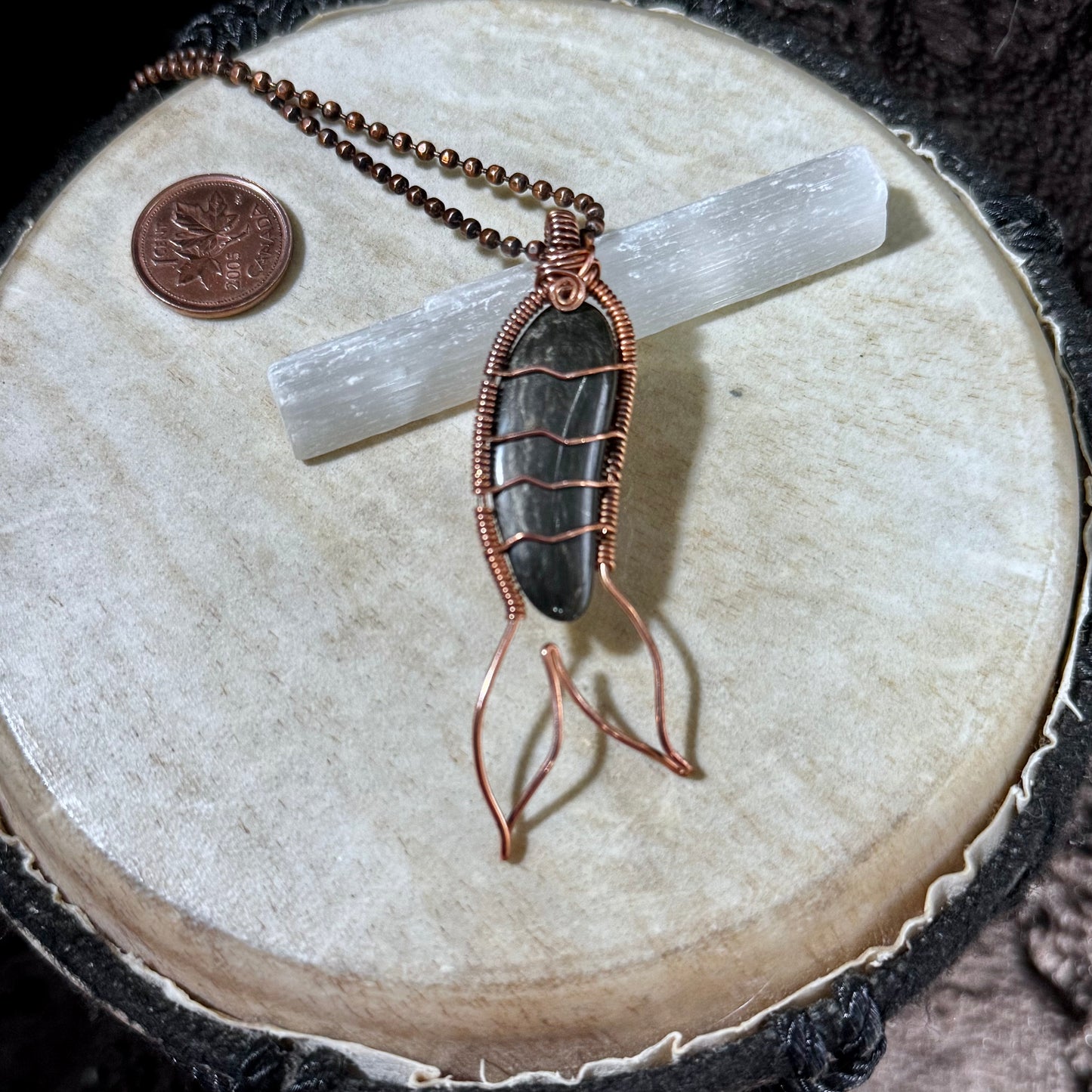 Handcrafted Mermaid Tail necklace featuring a polished Bay of Fundy black agate wrapped in reclaimed copper with flowing tail fins and suspended from a copper ball chain.