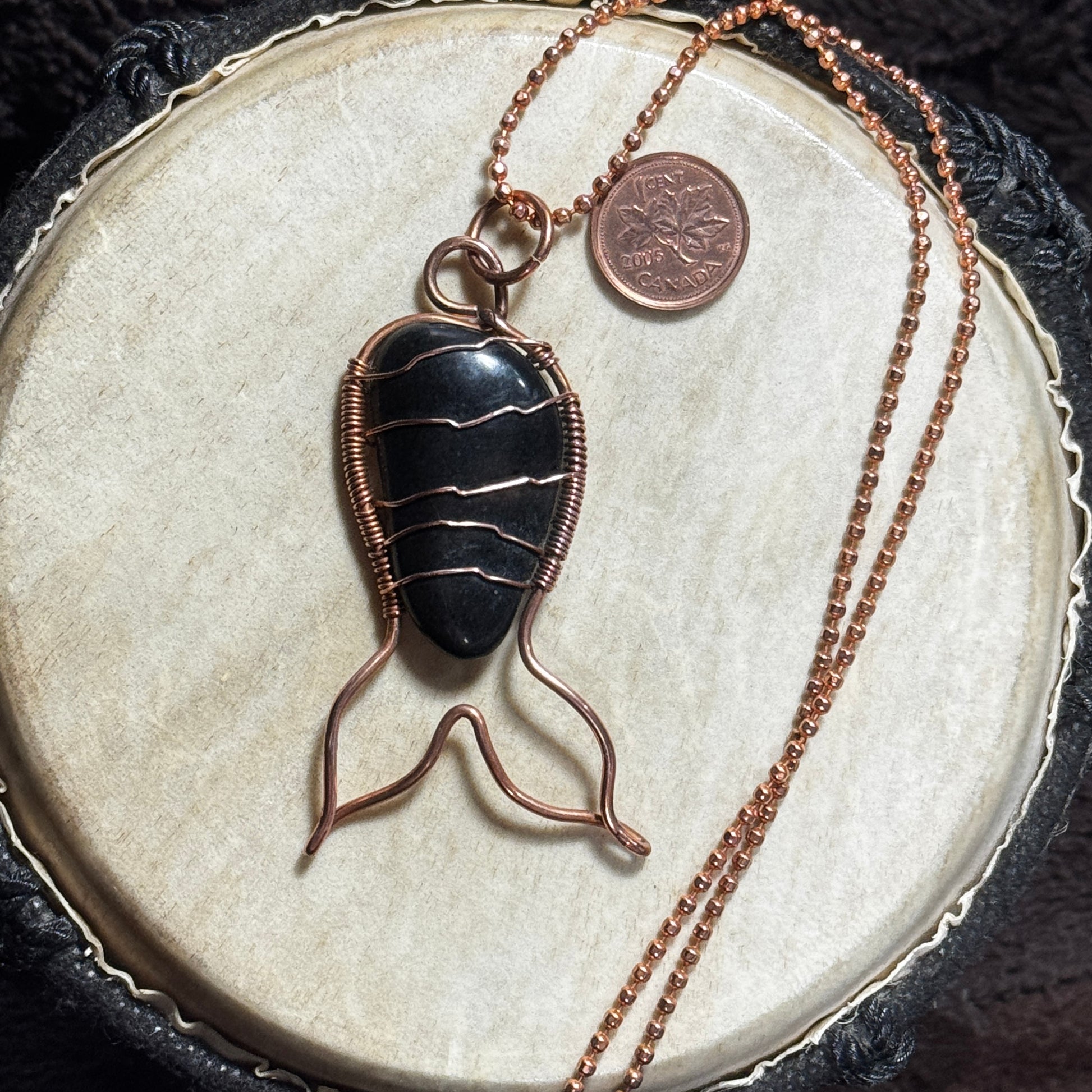 Front view of a handmade black agate Mermaid Tail necklace in raw copper on a 20 inch faceted copper ball chain.