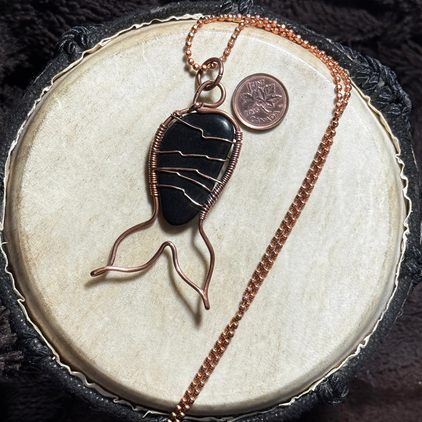 Back view of a black agate Mermaid Tail necklace in raw copper with faceted copper ball chain.
