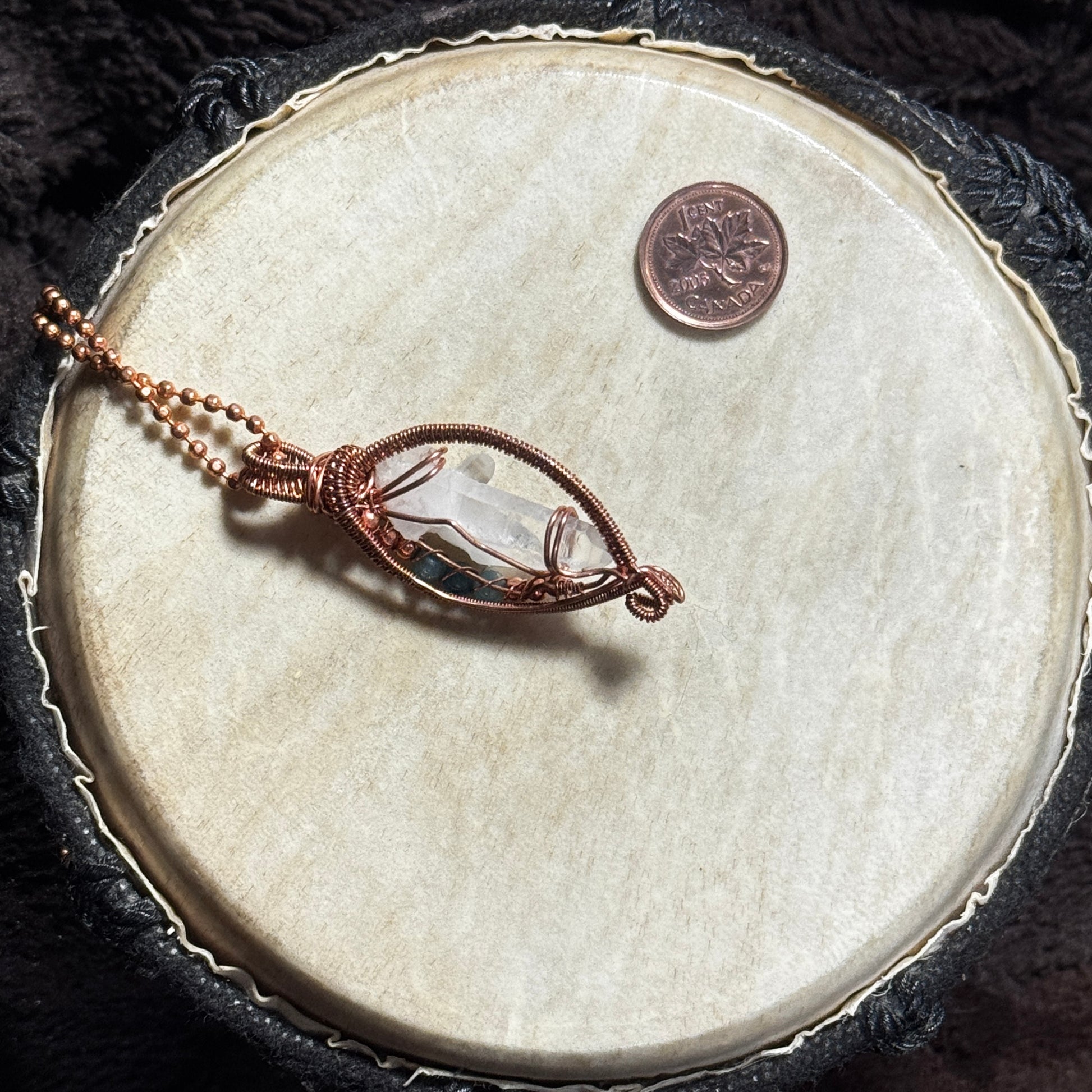 Rear view of a handmade Lemurian crystal pendant in fine raw copper open weave on a copper ball chain.