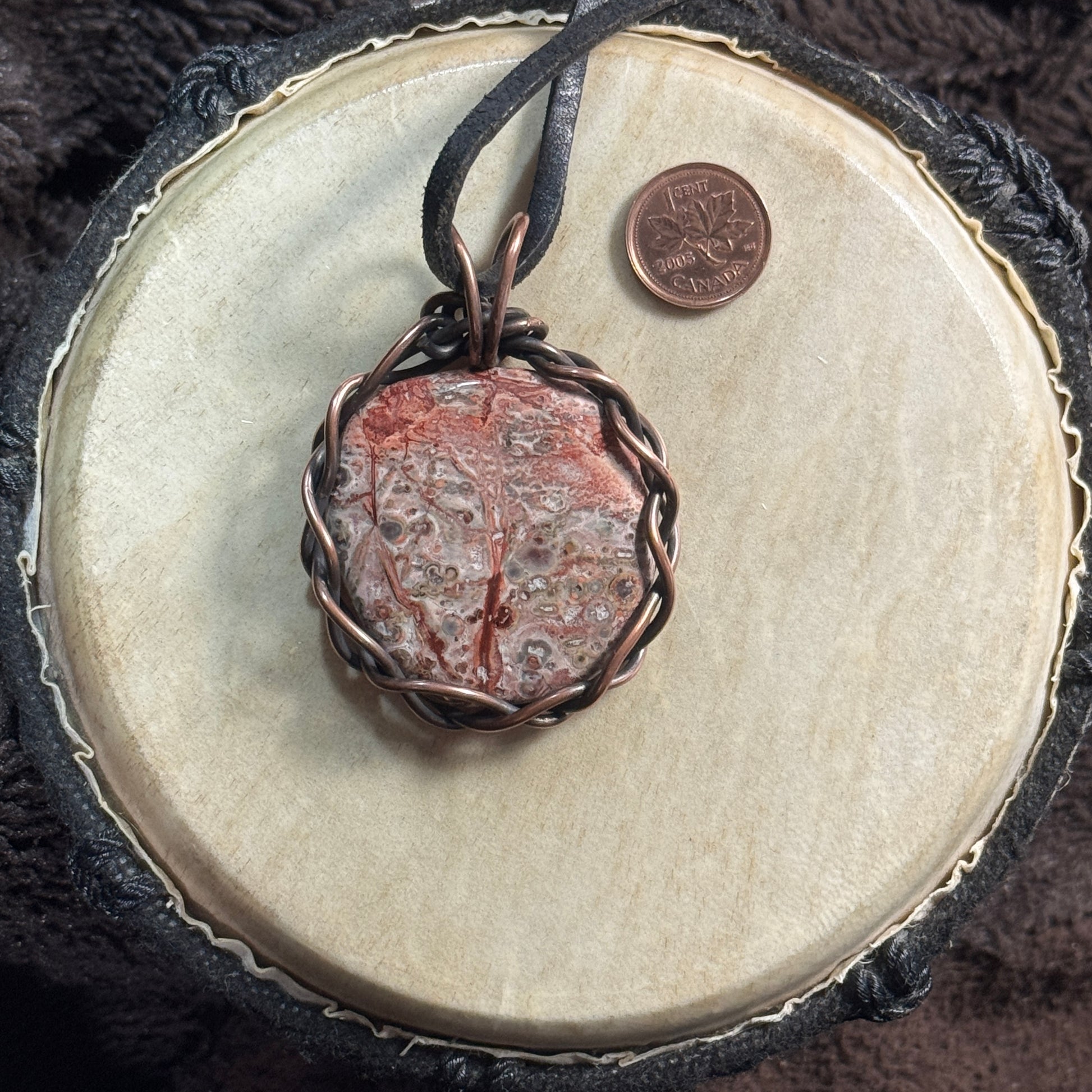 Reverse view of a reversible Leopardskin Jasper pendant in reclaimed patinated copper on reclaimed leather.