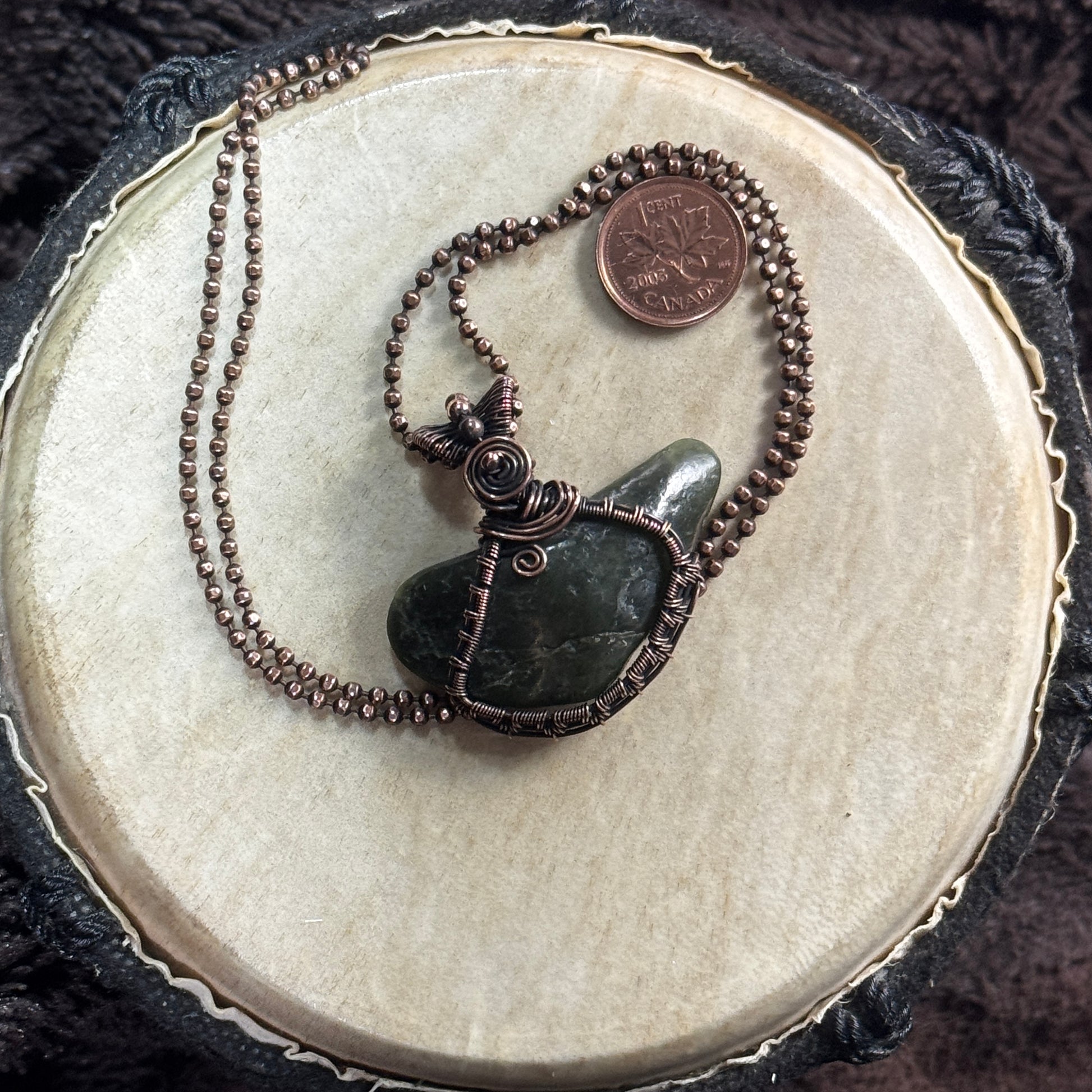 Front view of a handmade tumbled BC jade necklace wrapped in detailed patinated copper with spiral wirework and faceted copper ball chain.