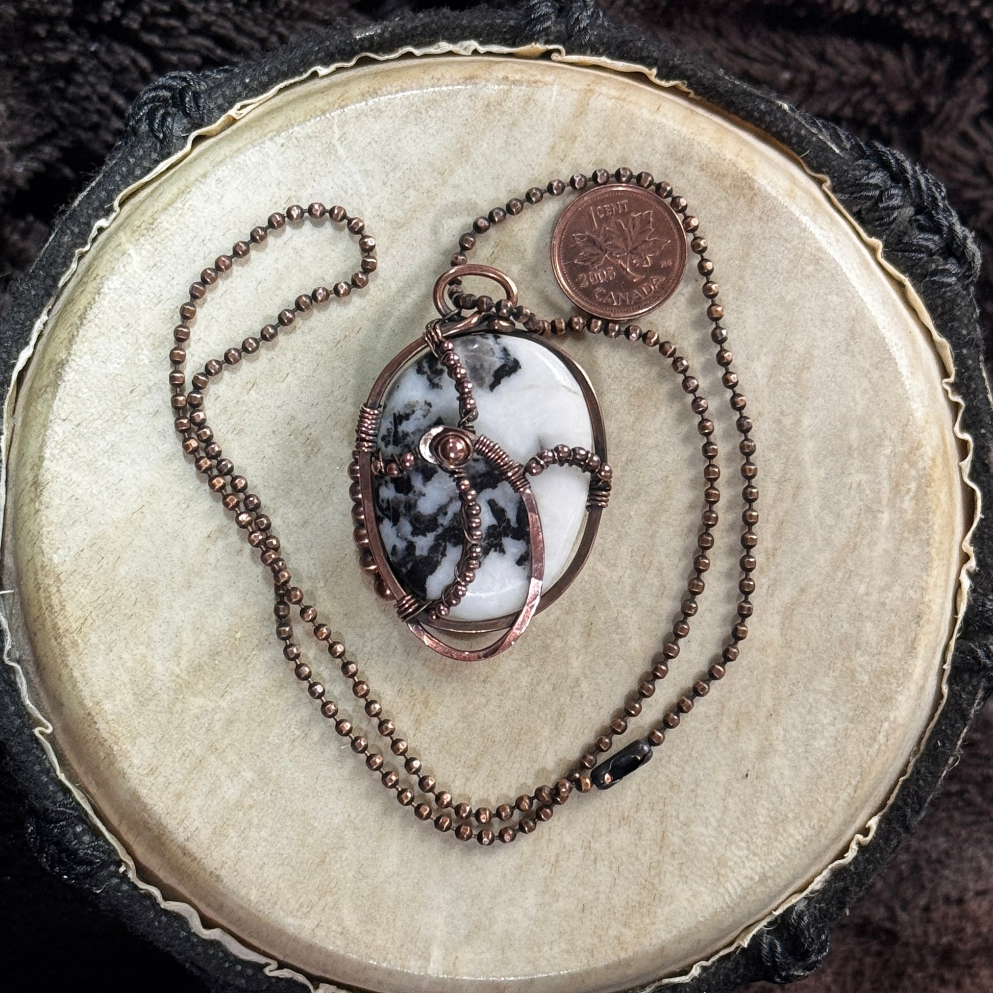 Front view of a handmade moss agate necklace in copper with a hand-planished frame, copper bead accents, and a 20 inch faceted copper ball chain.
