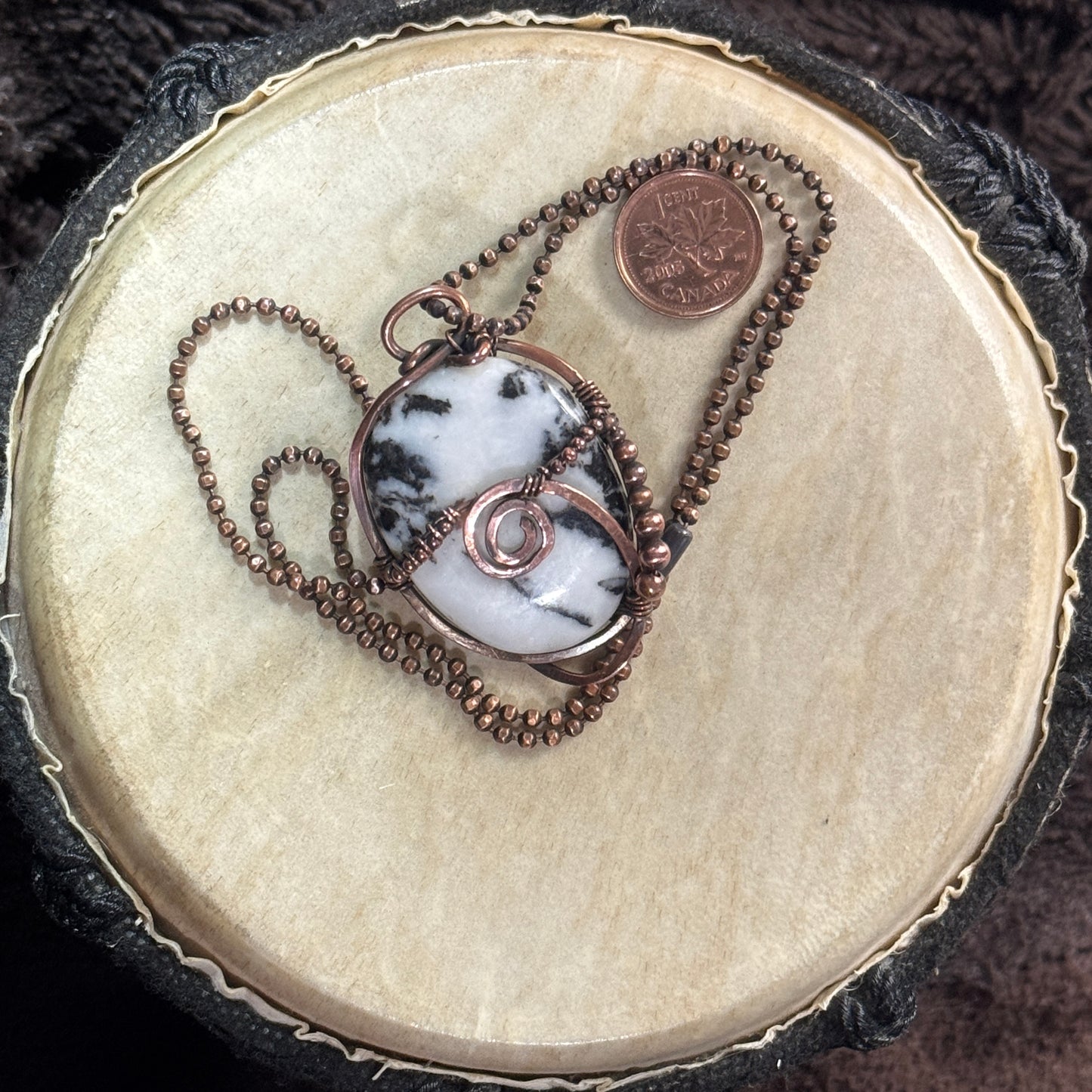Reverse view of a reversible moss agate pendant wrapped in copper with a spiral detail and copper bead accents on a faceted copper ball chain.