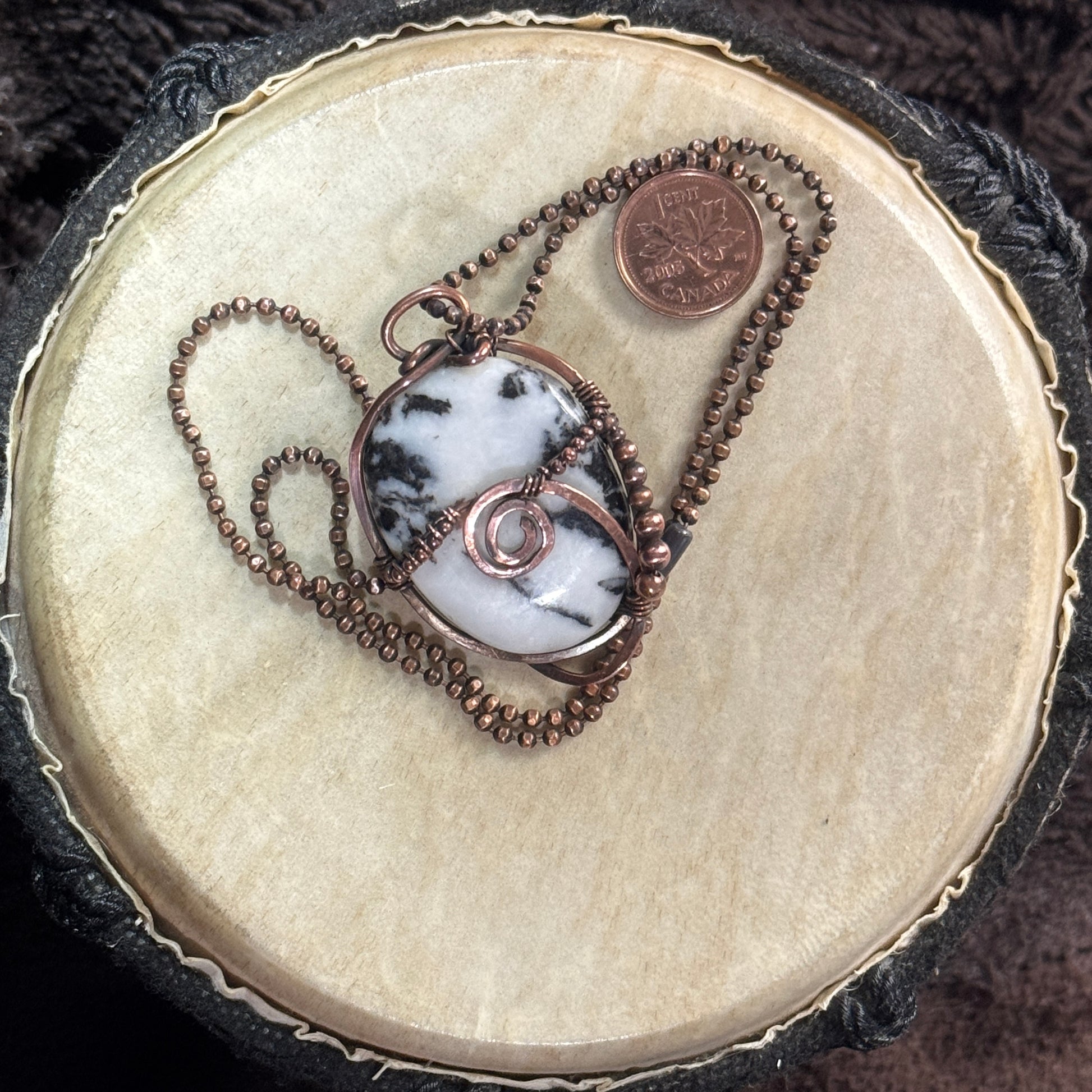 Reverse view of a reversible moss agate pendant wrapped in copper with a spiral detail and copper bead accents on a faceted copper ball chain.