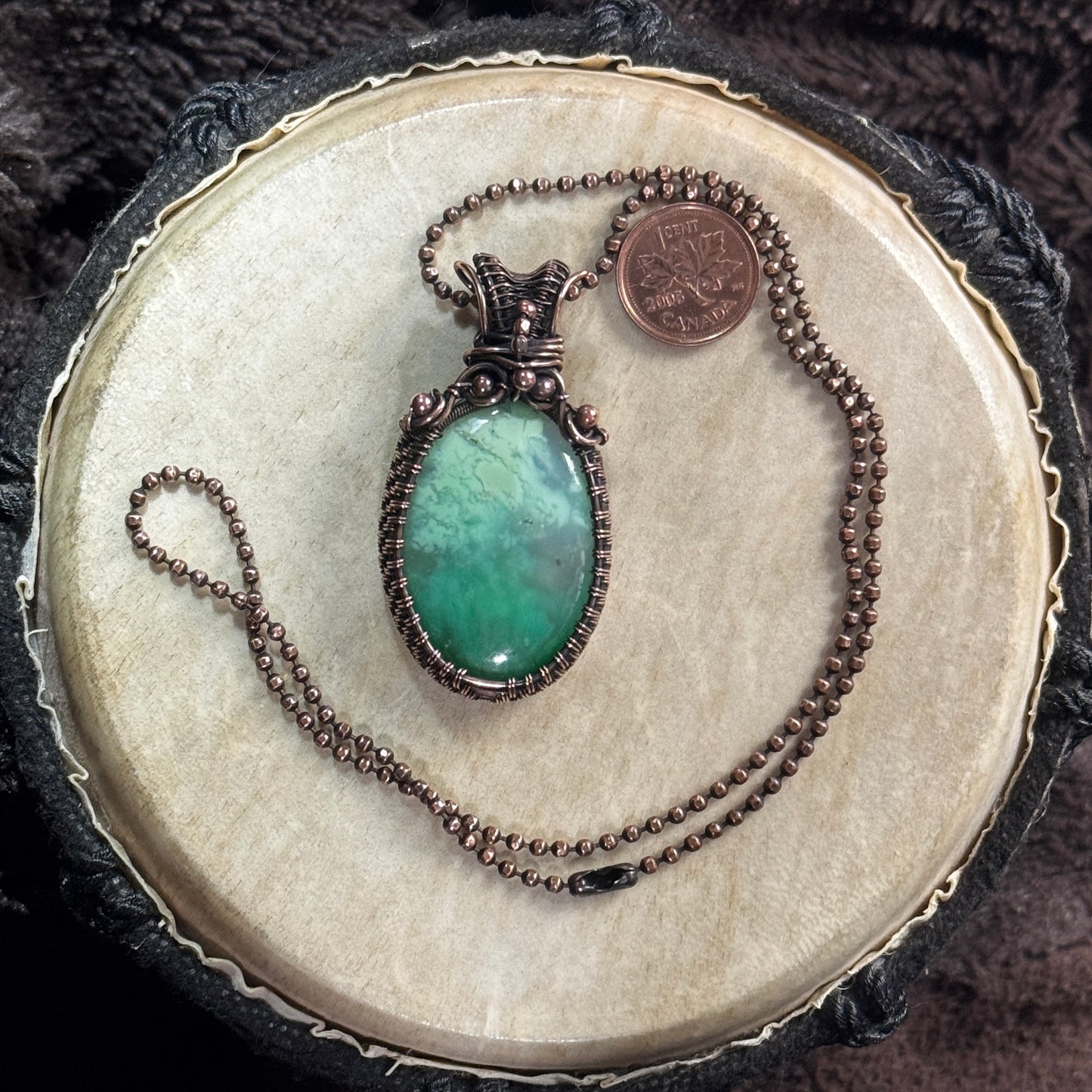 Front view of a handmade agatized chrysoprase cabochon necklace in patinated copper on a 20 inch faceted copper ball chain.