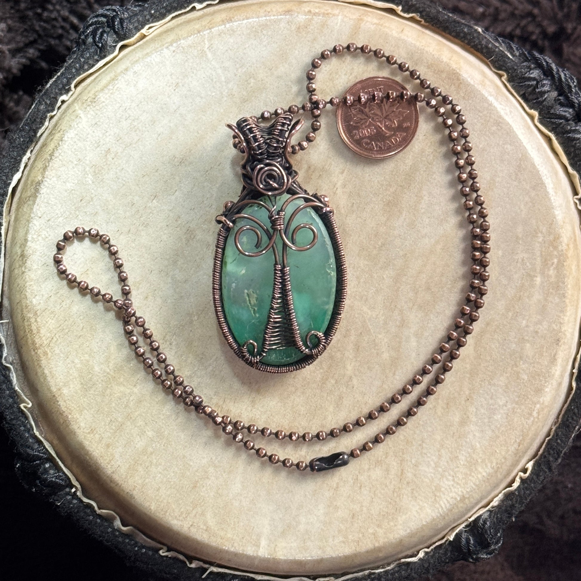Back view of a handcrafted agatized chrysoprase necklace in patinated copper with an elegant tree-like wire design on the reverse.