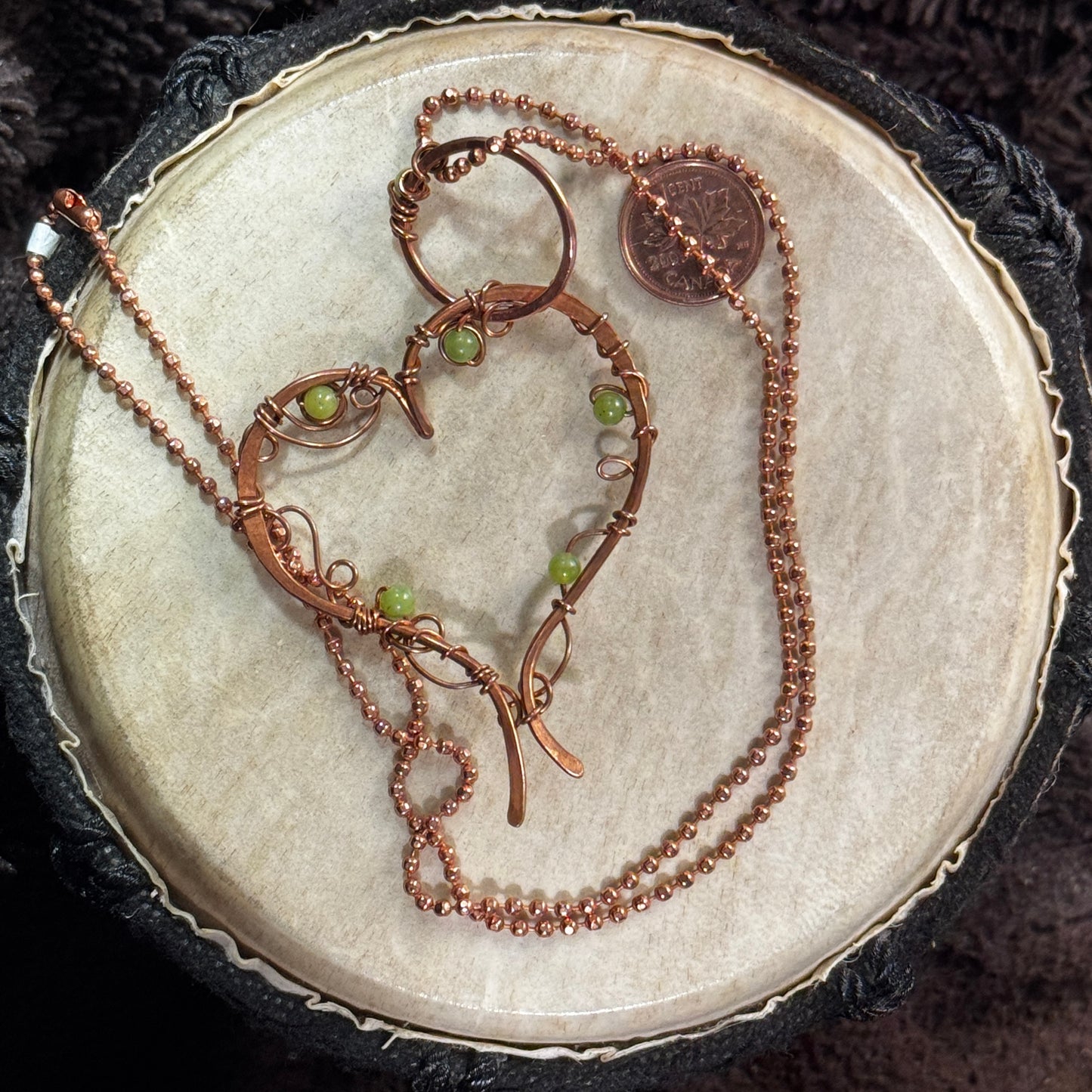 Alternate view of a handmade raw copper heart pendant accented with lemon jade beads and suspended from a faceted copper ball chain.