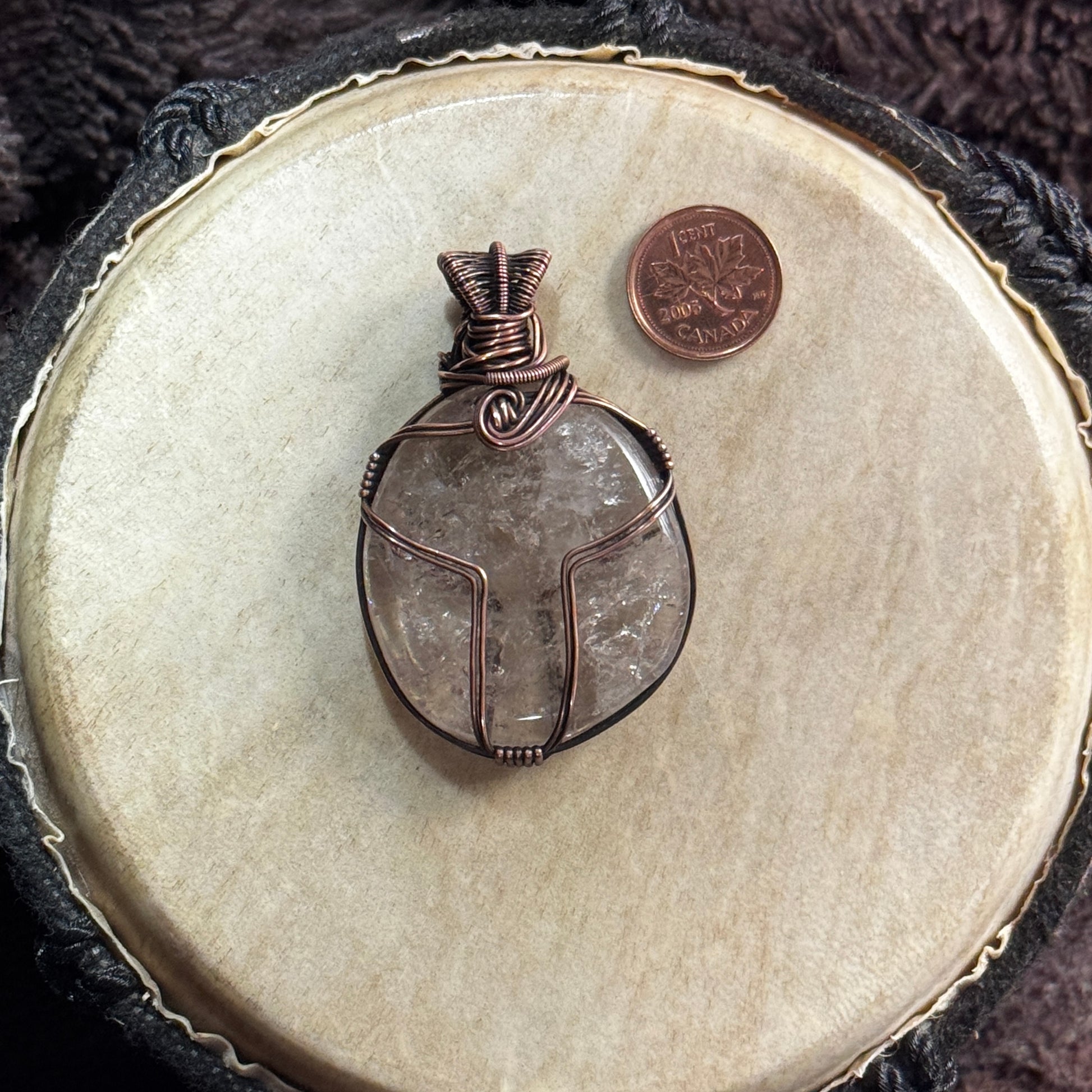 Side two of a reversible smoky quartz pendant showing its alternate copper framework, natural smoky veils and internal inclusions.