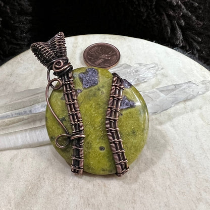 Atlantisite palm stone pendant wrapped in reclaimed copper with green serpentine and purple stichtite inclusions
