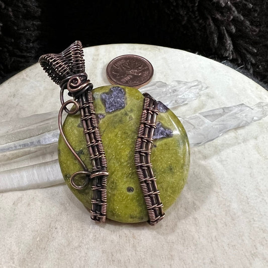 Atlantisite palm stone pendant wrapped in reclaimed copper with green serpentine and purple stichtite inclusions