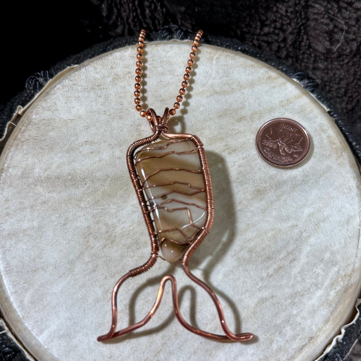 Rear view of a handcrafted Bay of Fundy Jasper Mermaid Tail pendant wrapped in reclaimed copper, highlighting the secure artisan wirework and one-of-a-kind natural stone.