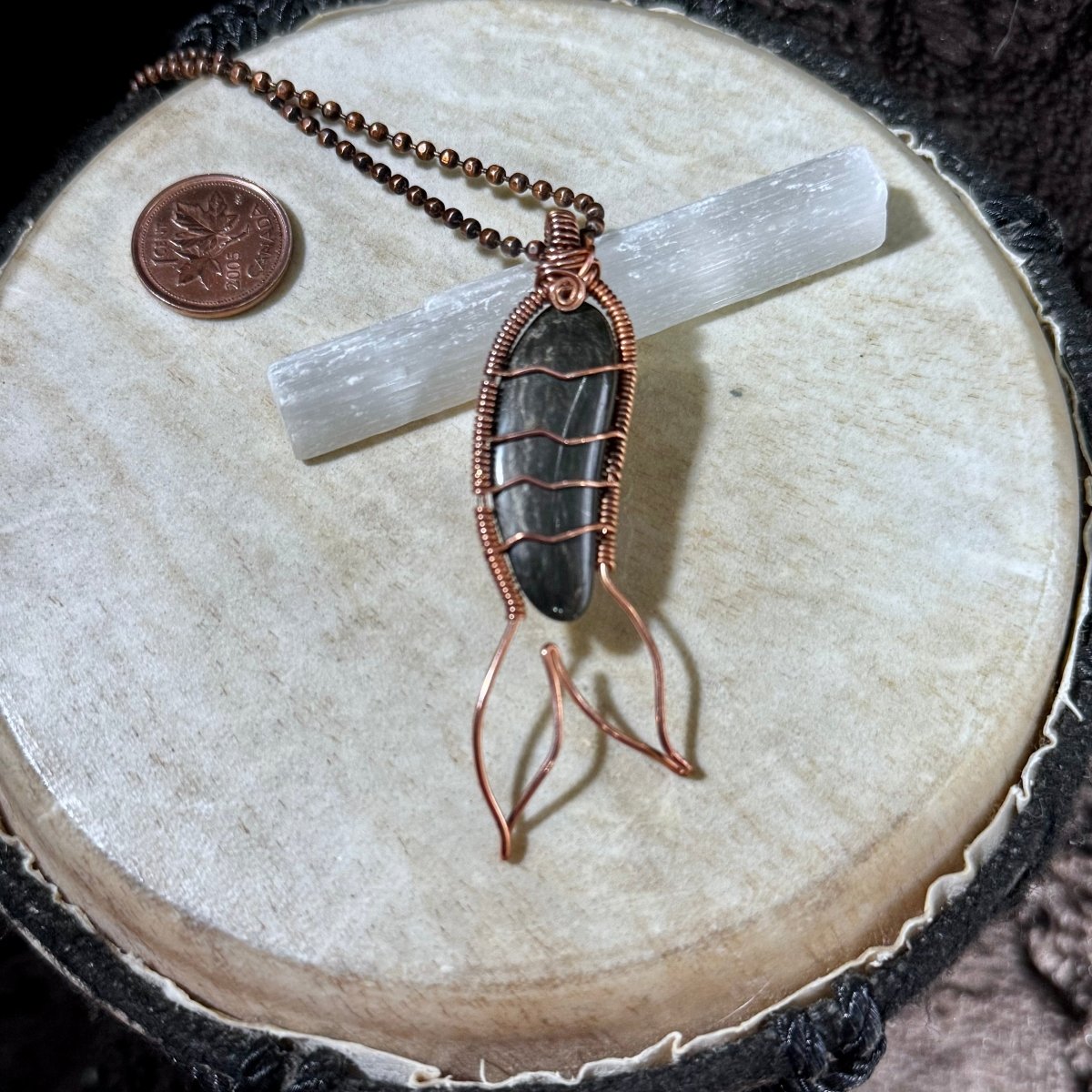 Handcrafted Mermaid Tail necklace featuring a polished Bay of Fundy black agate wrapped in reclaimed copper with flowing tail fins and suspended from a copper ball chain.