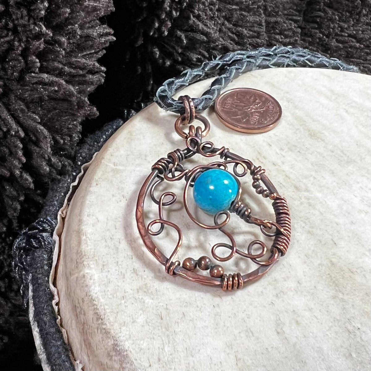 Close-up of freeform copper wire pendant with dyed magnesite bead, one-of-a-kind Mother of Metal necklace