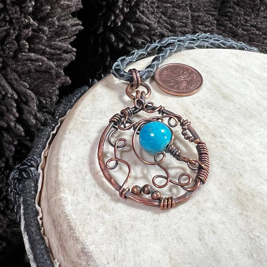 Close-up of freeform copper wire pendant with dyed magnesite bead, one-of-a-kind Mother of Metal necklace