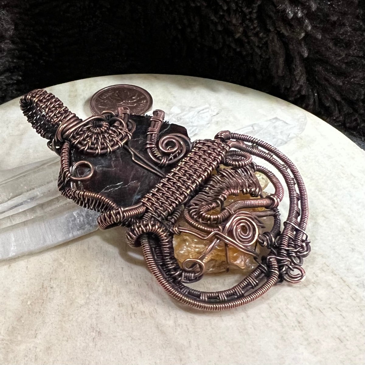 Back view of pendant showing intricate copper weaving and secure handcrafted structure