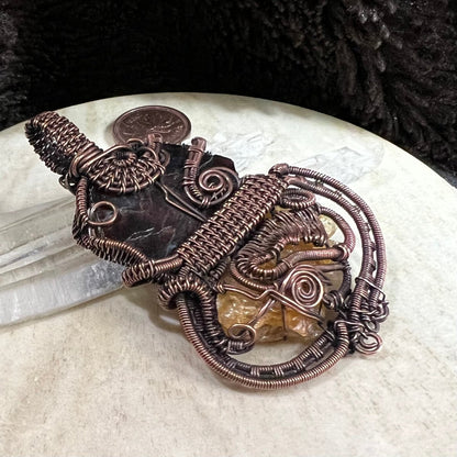 Back view of pendant showing intricate copper weaving and secure handcrafted structure