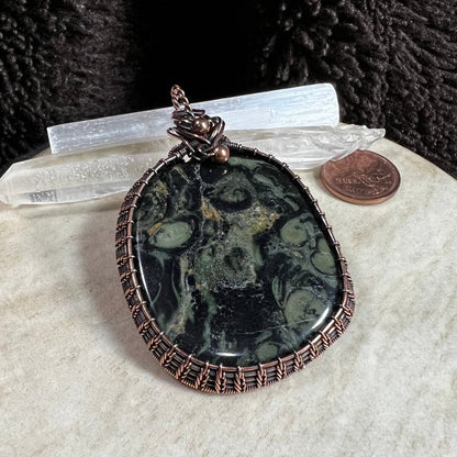 kambaba jasper pendant with dark green orb patterns wrapped in patinated copper handmade OOAK jewelry