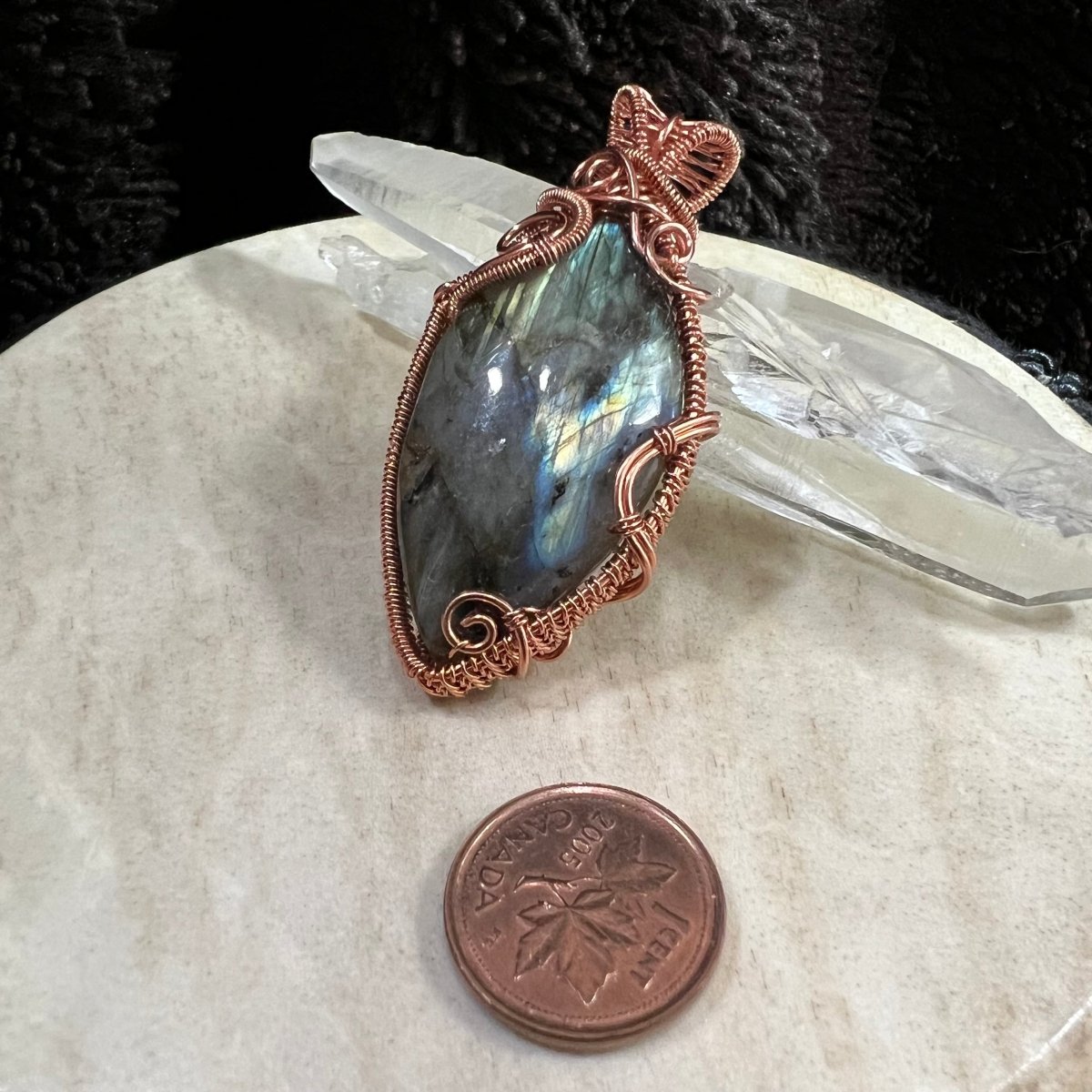labradorite pendant wrapped in reclaimed copper with blue and yellow flash, handmade protection crystal necklace with multi-coloured stone on neutral background