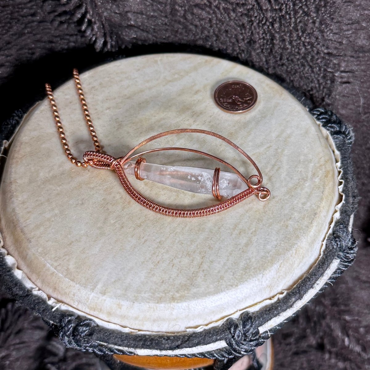 Front view of The Memory Vessel necklace with a horizontal Lemurian Quartz point secured in sweeping reclaimed copper on a faceted copper ball chain.
