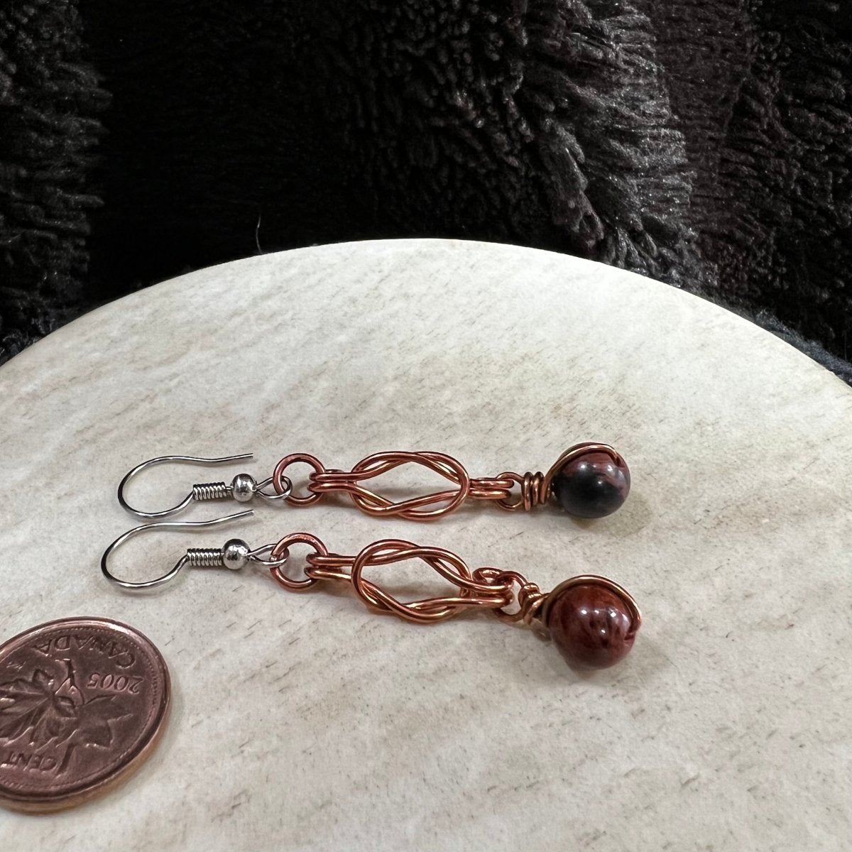 mahogany obsidian earrings with copper wire wrapped Sailor's knot and surgical steel earwires, handmade in Canada