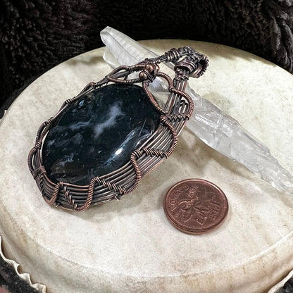 Dark green moss agate stone with subtle natural inclusions and glossy finish