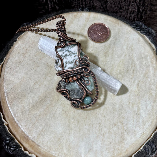 Front of the reversible Growthkeeper necklace with Moss Agate, raw Emerald, Green Aventurine and copper bead details in reclaimed copper.