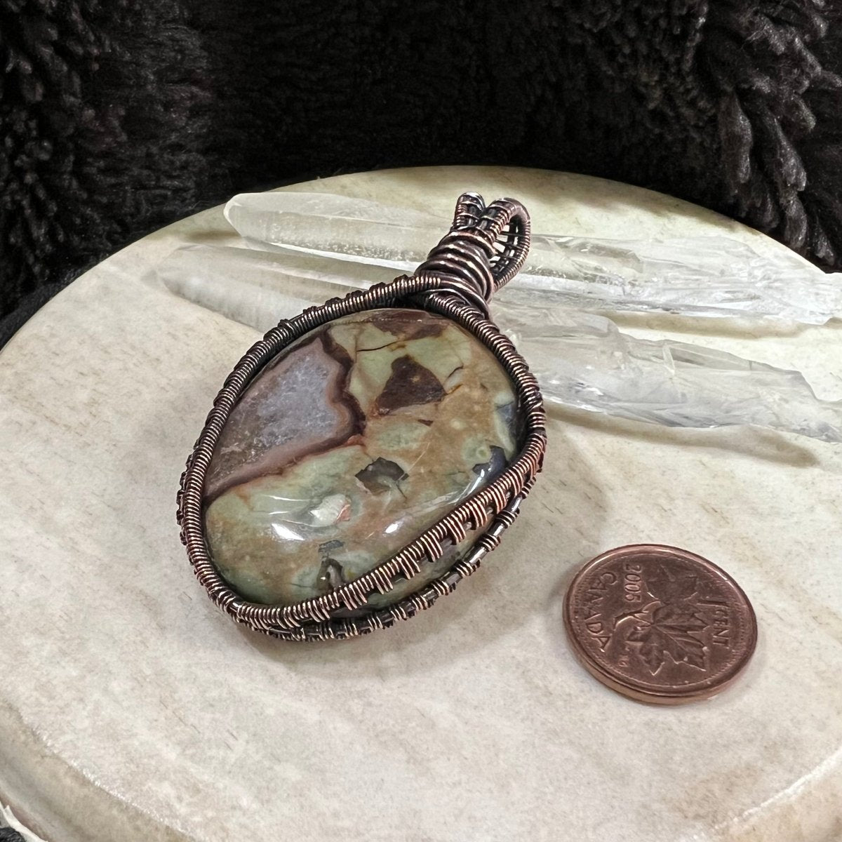 Detail of copper weave and patina finish framing gemstone