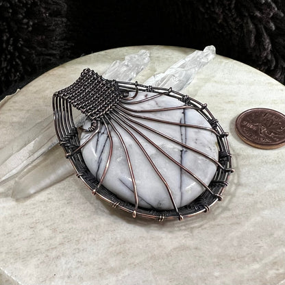 Back view of pendant showing handcrafted copper structure and secure wire design