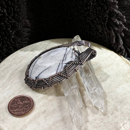 Picasso jasper pendant displayed with quartz crystals and Canadian penny  for scale and neutral contrast