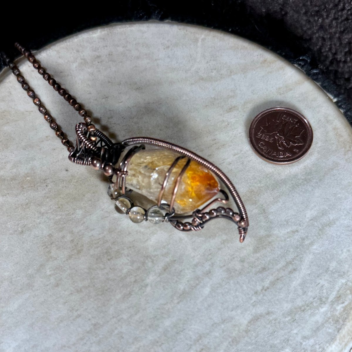 Close front view of a raw golden Citrine point framed in patinated reclaimed copper with Citrine and copper bead embellishments.