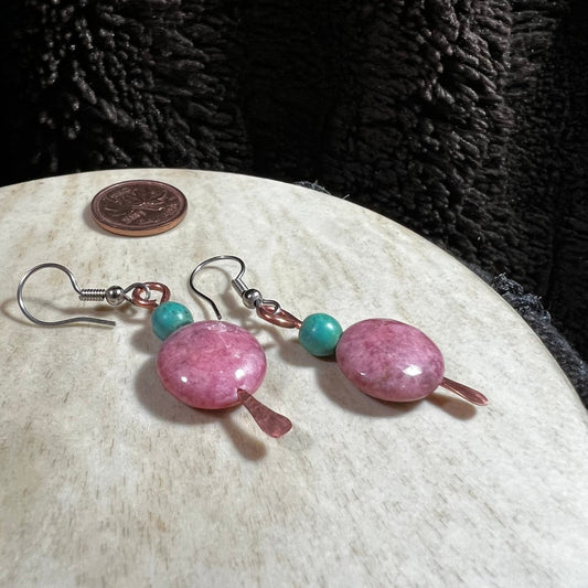 Pair of earrings with pink and turquoise beads on a white surface.