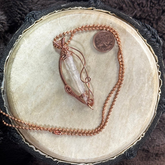 Lemurian quartz point held inside an open raw copper weave on a 21-inch faceted ball chain, with a Canadian penny shown for scale.