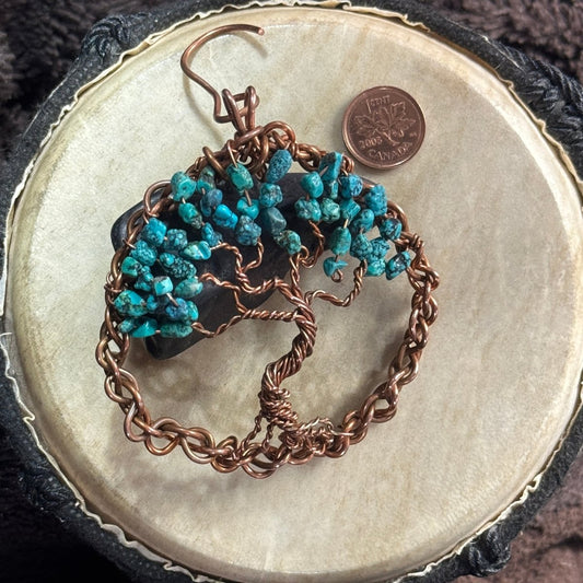 Three-inch reclaimed copper Tree of Life suncatcher with turquoise chip leaves, styled over black shungite with a Canadian penny for scale.