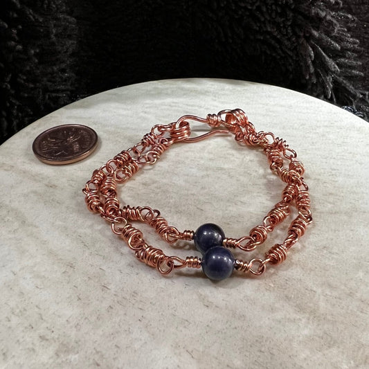 sodalite double strand bracelet with 6mm blue beads and reclaimed copper wire links, handmade calming clarity bracelet on neutral background next to a Canadian penny for scale