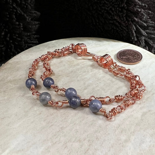 sodalite double strand bracelet with reclaimed copper wire links and blue stone beads, handmade calming crystal bracelet on neutral background