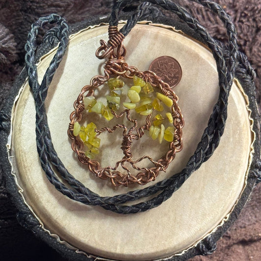 Full view of a 30-inch reclaimed black leather necklace with a 2.5-inch lemon jade Tree of Life pendant formed from raw reclaimed copper.