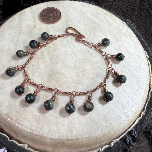 Handmade Kambaba Jasper charm bracelet with reclaimed copper wire-wrapped links and dangling green gemstone beads.