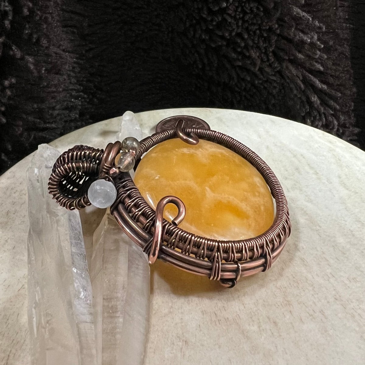 Side angle of OOAK copper pendant highlighting layered wirework and bead accents